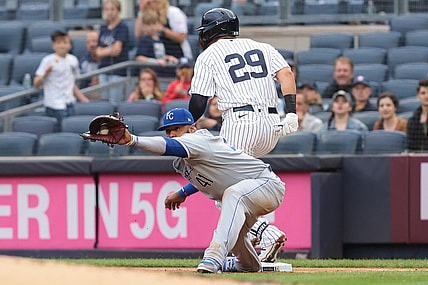Jun 22, 2021; Bronx, New York, USA; New York Yankees third baseman Gio Urshela (29) beats the throw caught by Kansas City Royals first baseman Carlos Santana (41) during the first inning at Yankee Stadium. Mandatory Credit: Vincent Carchietta-USA TODAY Sports