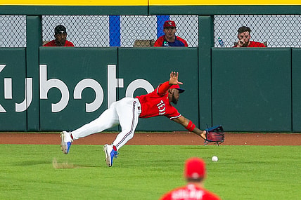Jun 25, 2021; Arlington, Texas, USA; Texas Rangers center fielder Adolis Garcia (53) dives for a ball during the third inning against the Kansas City Royals at Globe Life Field. Mandatory Credit: Andrew Dieb-USA TODAY Sports