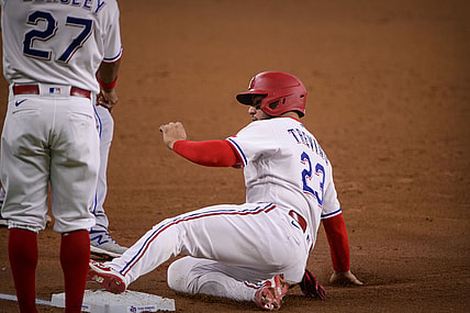 Jun 26, 2021; Arlington, Texas, USA; Texas Rangers catcher Jose Trevino (23) slides into third base during the second inning against the Kansas City Royals at Globe Life Field. Mandatory Credit: Jerome Miron-USA TODAY Sports