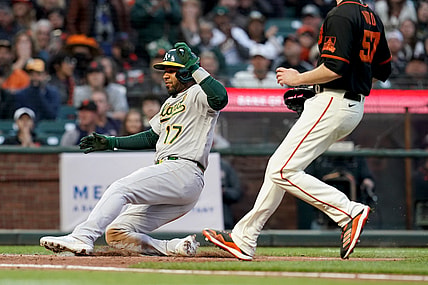 Jun 26, 2021; San Francisco, California, USA; Oakland Athletics shortstop Elvis Andrus (17) scores a run on a wild pitch against the San Francisco Giants in the third inning at Oracle Park. Mandatory Credit: Cary Edmondson-USA TODAY Sports