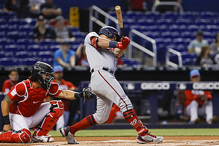 Jun 27, 2021; Miami, Florida, USA; Washington Nationals left fielder Kyle Schwarber (12) connects for a base hit against the Miami Marlins during the first inning at loanDepot Park. Mandatory Credit: Sam Navarro-USA TODAY Sports