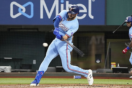 Jun 27, 2021; Arlington, Texas, USA; Texas Rangers right fielder Joey Gallo (13) hits a two run home run against the Kansas City Royals during the first inning of a baseball game at Globe Life Field. Mandatory Credit: Jim Cowsert-USA TODAY Sports