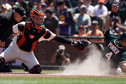 Jun 27, 2021; San Francisco, California, USA; San Francisco Giants catcher Buster Posey (28) misses a tag as Oakland Athletics left fielder Chad Pinder (4) scores a run during the sixth inning at Oracle Park. Mandatory Credit: Darren Yamashita-USA TODAY Sports