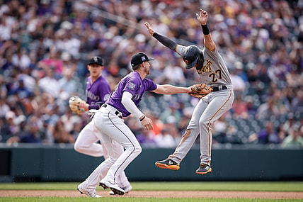 Jun 28, 2021; Denver, Colorado, USA; Pittsburgh Pirates second baseman Kevin Newman (27) avoids the tag from Colorado Rockies second baseman Ryan McMahon (24) as he runs to third in the fifth inning at Coors Field. Mandatory Credit: Isaiah J. Downing-USA TODAY Sports