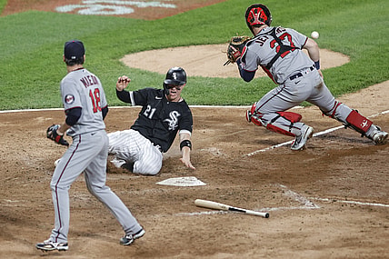 Jun 29, 2021; Chicago, Illinois, USA; Chicago White Sox catcher Zack Collins (21) scores a run as Minnesota Twins catcher Ryan Jeffers (27) waits for the ball during the fifth inning at Guaranteed Rate Field. Mandatory Credit: Kamil Krzaczynski-USA TODAY Sports