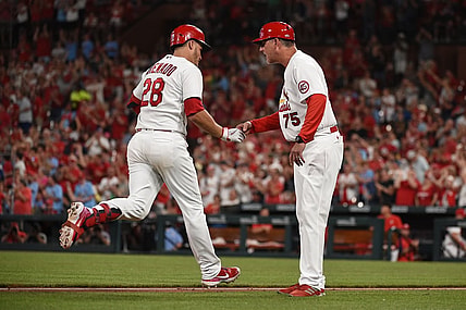 Jun 29, 2021; St. Louis, Missouri, USA; St. Louis Cardinals third baseman Nolan Arenado (28) is congratulated by third base coach Ron 'Pop' Warner (75) after hitting a two run home run against the Arizona Diamondbacks during the fifth inning at Busch Stadium. Mandatory Credit: Joe Puetz-USA TODAY Sports