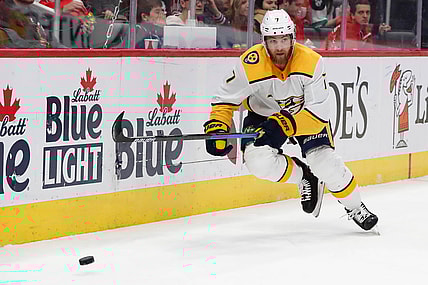 Nov 4, 2019; Detroit, MI, USA; Nashville Predators defenseman Yannick Weber (7) goes after the puck in the first period against the Detroit Red Wings at Little Caesars Arena. Mandatory Credit: Rick Osentoski-USA TODAY Sports