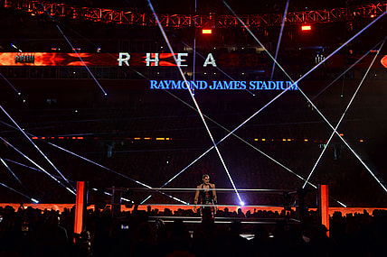 Apr 11, 2021; Tampa, Florida, USA; Asuka (green/yellow attire) and Rhea Ripley (black attire) during the Raw Women's Championship match at WrestleMania 37 at Raymond James Stadium. Mandatory Credit: Joe Camporeale-USA TODAY Sports