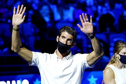 Jun 18, 2021; Omaha, Nebraska, USA; Michael Phelps waves to the crowd during the Medal Ceremony during the U.S. Olympic Team Trials Swimming competition at CHI Health Center Omaha. Mandatory Credit: Rob Schumacher-USA TODAY Sports