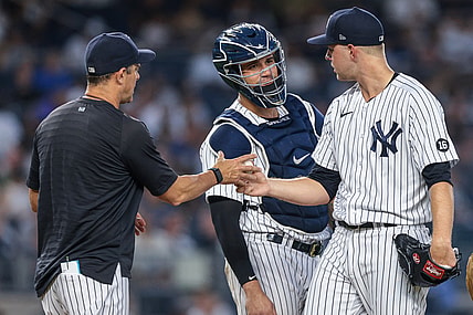 Jun 28, 2021; Bronx, New York, USA; New York Yankees starting pitcher Michael King (73) hands the ball to  manager Aaron Boone (17) while talking with catcher Gary Sanchez (24) during the fifth inning against the Los Angeles Angels at Yankee Stadium. Mandatory Credit: Vincent Carchietta-USA TODAY Sports