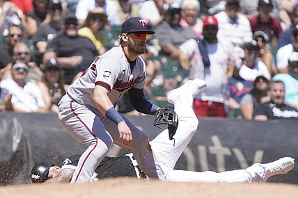 Jul 1, 2021; Chicago, Illinois, USA; Chicago White Sox third baseman Yoan Moncada (10) is safe at third base as Minnesota Twins third baseman Josh Donaldson (20) takes a late throw during the third inning at Guaranteed Rate Field. Mandatory Credit: David Banks-USA TODAY Sports