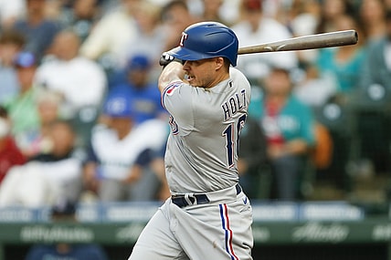 Jul 2, 2021; Seattle, Washington, USA; Texas Rangers third baseman Brock Holt (16) hits a two run single against the Seattle Mariners during the third inning at T-Mobile Park. Mandatory Credit: Joe Nicholson-USA TODAY Sports