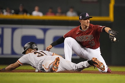 Jul 2, 2021; Phoenix, Arizona, USA; San Francisco Giants center fielder LaMonte Wade Jr (31) dives into secondbase under the tag of Arizona Diamondbacks shortstop Nick Ahmed (13) after hitting a double in the third inning at Chase Field. Mandatory Credit: Rick Scuteri-USA TODAY Sports