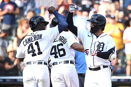 Jul 3, 2021; Detroit, Michigan, USA; Detroit Tigers left fielder Eric Haase (13) celebrates his home run with Chicago White Sox bench coach Miguel Cairo (41) during the game at Comerica Park. Mandatory Credit: Tim Fuller-USA TODAY Sports