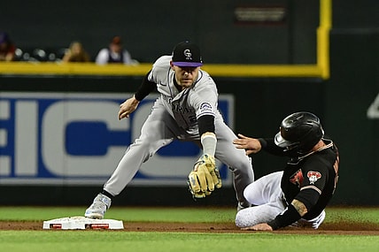 Jul 7, 2021; Phoenix, Arizona, USA;  Arizona Diamondbacks first baseman Christian Walker (53) is tagged out by Colorado Rockies shortstop Trevor Story (27) in the second inning at Chase Field. Mandatory Credit: Matt Kartozian-USA TODAY Sports