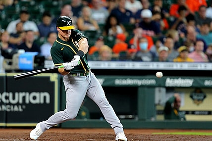Jul 8, 2021; Houston, Texas, USA; Oakland Athletics third baseman Matt Chapman (26) hits a single against the Houston Astros during the fifth inning at Minute Maid Park. Mandatory Credit: Erik Williams-USA TODAY Sports
