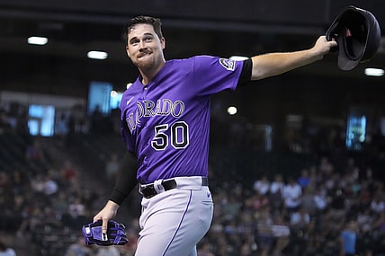 Jul 8, 2021; Phoenix, Arizona, USA; Colorado Rockies starting pitcher Chi Chi Gonzalez (50) reacts after hitting an RBI single against the Arizona Diamondbacks in the fourth inning at Chase Field. Mandatory Credit: Rick Scuteri-USA TODAY Sports