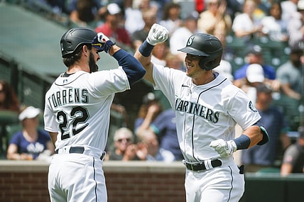 Jul 8, 2021; Seattle, Washington, USA; Seattle Mariners second baseman Dylan Moore (right) celebrates with designated hitter Luis Torrens (22) after hitting a two-run home run against the New York Yankees during the second inning at T-Mobile Park. Mandatory Credit: Joe Nicholson-USA TODAY Sports