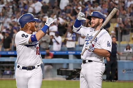 Jul 10, 2021; Los Angeles, California, USA; Los Angeles Dodgers third baseman Justin Turner (10) celebrates with second baseman Max Muncy (right) after hitting a grand slam home run against the Arizona Diamondbacks in the second inning at Dodger Stadium. Mandatory Credit: Kirby Lee-USA TODAY Sports