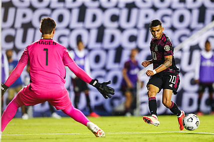 Jul 14, 2021; Dallas, Texas, USA; Mexico midfielder Orbel    n Pineda (10) assists a goal by Mexico forward Rogelio Funes Mori (not pictured) against Guatemala goalkeeper Nicholas Hagen (1) during the second half of CONCACAF Gold Cup Soccer group stage play at Cotton Bowl. Mandatory Credit: Ben Ludeman-USA TODAY Sports