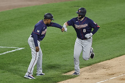 Jul 19, 2021; Chicago, Illinois, USA; Minnesota Twins center fielder Mitch Garver (8) celebrates with third base coach Tony Diaz (46) after hitting a solo home run against the Chicago White Sox during the fifth inning of a Game 2 of the doubleheader at Guaranteed Rate Field. Mandatory Credit: Kamil Krzaczynski-USA TODAY Sports