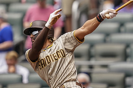 Jul 21, 2021; Cumberland, Georgia, USA; San Diego Padres shortstop Fernando Tatis Jr. (23) singles against the Atlanta Braves during the first inning at Truist Park. Mandatory Credit: Dale Zanine-USA TODAY Sports