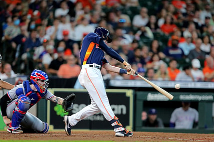 Jul 25, 2021; Houston, Texas, USA; Houston Astros right fielder Kyle Tucker (30) hits an RBI single against the Texas Rangers during the sixth inning at Minute Maid Park. Mandatory Credit: Erik Williams-USA TODAY Sports