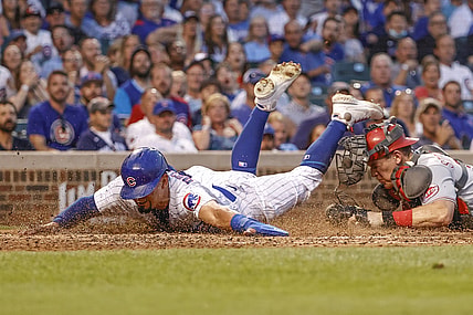 Jul 27, 2021; Chicago, Illinois, USA; Cincinnati Reds catcher Tyler Stephenson (37) tags out at home plate Chicago Cubs left fielder Rafael Ortega (66) during the third inning at Wrigley Field. Mandatory Credit: Kamil Krzaczynski-USA TODAY Sports