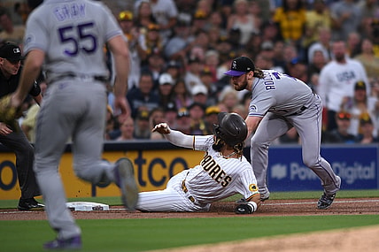 Jul 30, 2021; San Diego, California, USA; Colorado Rockies shortstop Brendan Rodgers (7) tags out San Diego Padres shortstop Fernando Tatis Jr. (center) at third base during the first inning at Petco Park. Tatis was injured on the play. Mandatory Credit: Orlando Ramirez-USA TODAY Sports