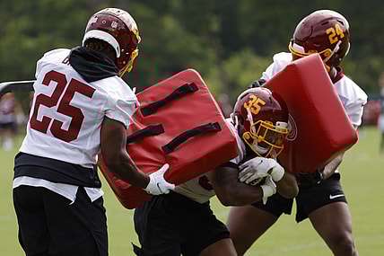Jun 10, 2021; Ashburn, VA, USA; Washington Football Team running back Lamar Miller (35) carries the ball between Washington Football Team running back Payton Barber (25) and Washington Football Team running back Antonio Gibson (24) during drills as part of minicamp at Inova Sports Performance Center. Mandatory Credit: Geoff Burke-USA TODAY Sports