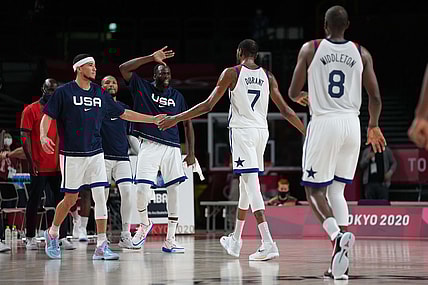 Jul 31, 2021; Saitama, Japan; Team United States guard Devin Booker (15) and Team United States centre Draymond Green (14) celebrate with Team United States forward Kevin Durant (7) at the end of the third quarter against Czech Republic during the Tokyo 2020 Olympic Summer Games at Saitama Super Arena. Mandatory Credit: Kareem Elgazzar-USA TODAY Sports