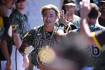 Aug 1, 2021; San Diego, California, USA; San Diego Padres shortstop Ha-seong Kim (7) is congratulated in the dugout after hitting a home run against the Colorado Rockies during the sixth inning at Petco Park. Mandatory Credit: Orlando Ramirez-USA TODAY Sports