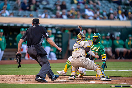Aug 3, 2021; Oakland, California, USA; Oakland Athletics second baseman Josh Harrison (1) is tagged out at home plate by San Diego Padres catcher Austin Nola (26) during the second inning at RingCentral Coliseum. Mandatory Credit: Neville E. Guard-USA TODAY Sports