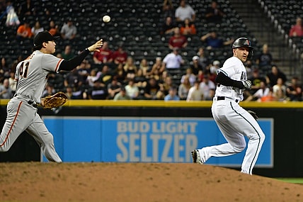 Aug 3, 2021; Phoenix, Arizona, USA; Arizona Diamondbacks shortstop Nick Ahmed (right) is caught in a run down by San Francisco Giants second baseman Wilmer Flores (41) in the fourth inning at Chase Field. Mandatory Credit: Matt Kartozian-USA TODAY Sports