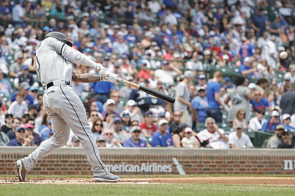 Aug 7, 2021; Chicago, Illinois, USA; Chicago White Sox third baseman Yoan Moncada (10) hits a two-run double against the Chicago Cubs during the first inning at Wrigley Field. Mandatory Credit: Kamil Krzaczynski-USA TODAY Sports