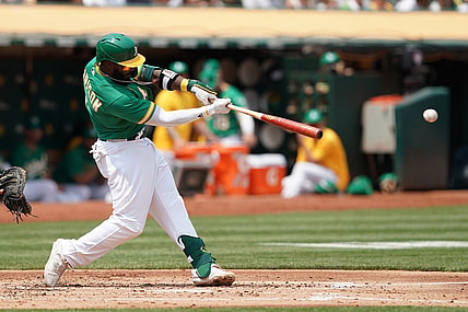Aug 7, 2021; Oakland, California, USA; Oakland Athletics second baseman Josh Harrison (1) hits a single during the second inning against the Texas Rangers at RingCentral Coliseum. Mandatory Credit: Darren Yamashita-USA TODAY Sports