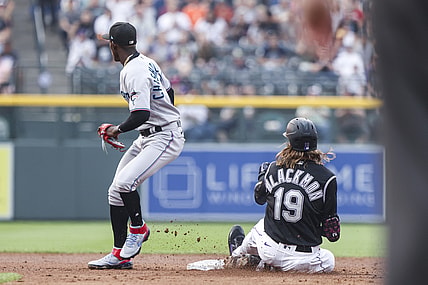 Aug 7, 2021; Denver, Colorado, USA; Colorado Rockies right fielder Charlie Blackmon (19) slides safely into second base past Miami Marlins second baseman Jazz Chisholm Jr. (2) after hitting a double in the second inning at Coors Field. Mandatory Credit: Michael Ciaglo-USA TODAY Sports
