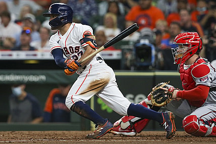 Aug 7, 2021; Houston, Texas, USA; Houston Astros second baseman Jose Altuve (27) hits a single against the Minnesota Twins in the fifth inning at Minute Maid Park. Mandatory Credit: Thomas Shea-USA TODAY Sports