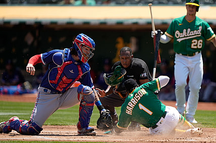Aug 8, 2021; Oakland, California, USA; Oakland Athletics second baseman Josh Harrison (1) slides in safe against Texas Rangers catcher Jonah Heim (28) during the first inning at RingCentral Coliseum. Mandatory Credit: Stan Szeto-USA TODAY Sports
