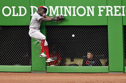Aug 9, 2021; Cleveland, Ohio, USA; Cincinnati Reds center fielder Aristides Aquino (44) collides with the wall while running after a ball hit for a RBI triple by Cleveland Indians third baseman Jose Ramirez (not pictured) in the third inning at Progressive Field. Mandatory Credit: David Richard-USA TODAY Sports
