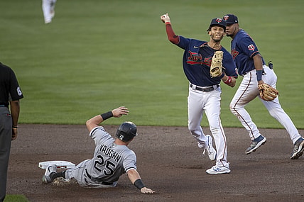 Aug 10, 2021; Minneapolis, Minnesota, USA; Minnesota Twins shortstop Andrelton Simmons (9) turns a double play over Chicago White Sox left fielder Andrew Vaughn (25) in the second inning at Target Field. Mandatory Credit: Jesse Johnson-USA TODAY Sports
