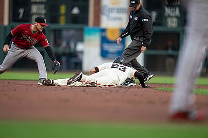 Aug 11, 2021; San Francisco, California, USA;  San Francisco Giants third baseman Kris Bryant (23) dives back into second base as Arizona Diamondbacks second baseman Josh VanMeter (19) attempts to tag him out during the first inning at Oracle Park. Mandatory Credit: Neville E. Guard-USA TODAY Sports