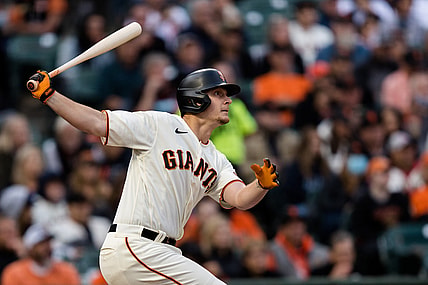Aug 12, 2021; San Francisco, California, USA; San Francisco Giants left fielder Alex Dickerson (12) hits an RBI double against the Colorado Rockies in the second inning at Oracle Park. Mandatory Credit: John Hefti-USA TODAY Sports