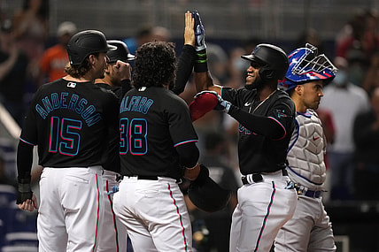 Aug 13, 2021; Miami, Florida, USA; Miami Marlins right fielder Bryan De La Cruz (77) celebrates with teammates after hitting a grand slam home run in the 2nd inning against the Chicago Cubs at loanDepot park. Mandatory Credit: Jasen Vinlove-USA TODAY Sports