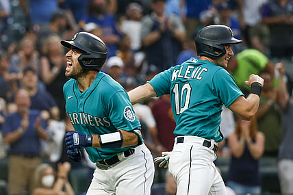 Aug 13, 2021; Seattle, Washington, USA; Seattle Mariners catcher Tom Murphy (2) celebrates with center fielder Jarred Kelenic (10) after hitting a two run home run against the Toronto Blue Jays during the third inning at T-Mobile Park. Kelenic scored a run on the hit. Mandatory Credit: Joe Nicholson-USA TODAY Sports