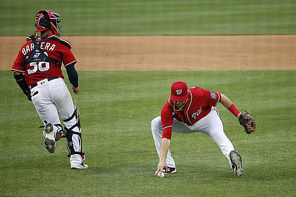 Aug 14, 2021; Washington, District of Columbia, USA; Washington Nationals third baseman Carter Kieboom (8) picks up a ground ball and throws to first against the Atlanta Braves in the fifth inning at Nationals Park. Mandatory Credit: Amber Searls-USA TODAY Sports