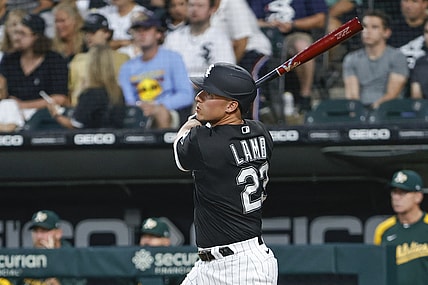 Aug 17, 2021; Chicago, Illinois, USA; Chicago White Sox third baseman Jake Lamb (23) hits a three-run home run against the Oakland Athletics during the second inning at Guaranteed Rate Field. Mandatory Credit: Kamil Krzaczynski-USA TODAY Sports