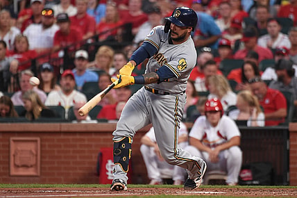 Aug 17, 2021; St. Louis, Missouri, USA; Milwaukee Brewers catcher Omar Narvaez (10) hits an RBI double against the St. Louis Cardinals during the third inning at Busch Stadium. Mandatory Credit: Joe Puetz-USA TODAY Sports