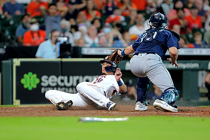 Aug 21, 2021; Houston, Texas, USA; Houston Astros left fielder Taylor Jones (28) beats a tag by Seattle Mariners catcher Cal Raleigh (29) while sliding into home plate to score a run during the fifth inning at Minute Maid Park. Mandatory Credit: Erik Williams-USA TODAY Sports