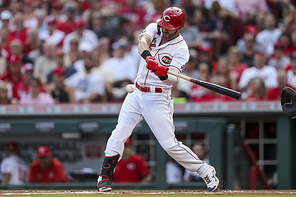 Aug 21, 2021; Cincinnati, Ohio, USA; Cincinnati Reds center fielder Tyler Naquin (12) hits a double against the Miami Marlins in the first inning at Great American Ball Park. Mandatory Credit: Katie Stratman-USA TODAY Sports